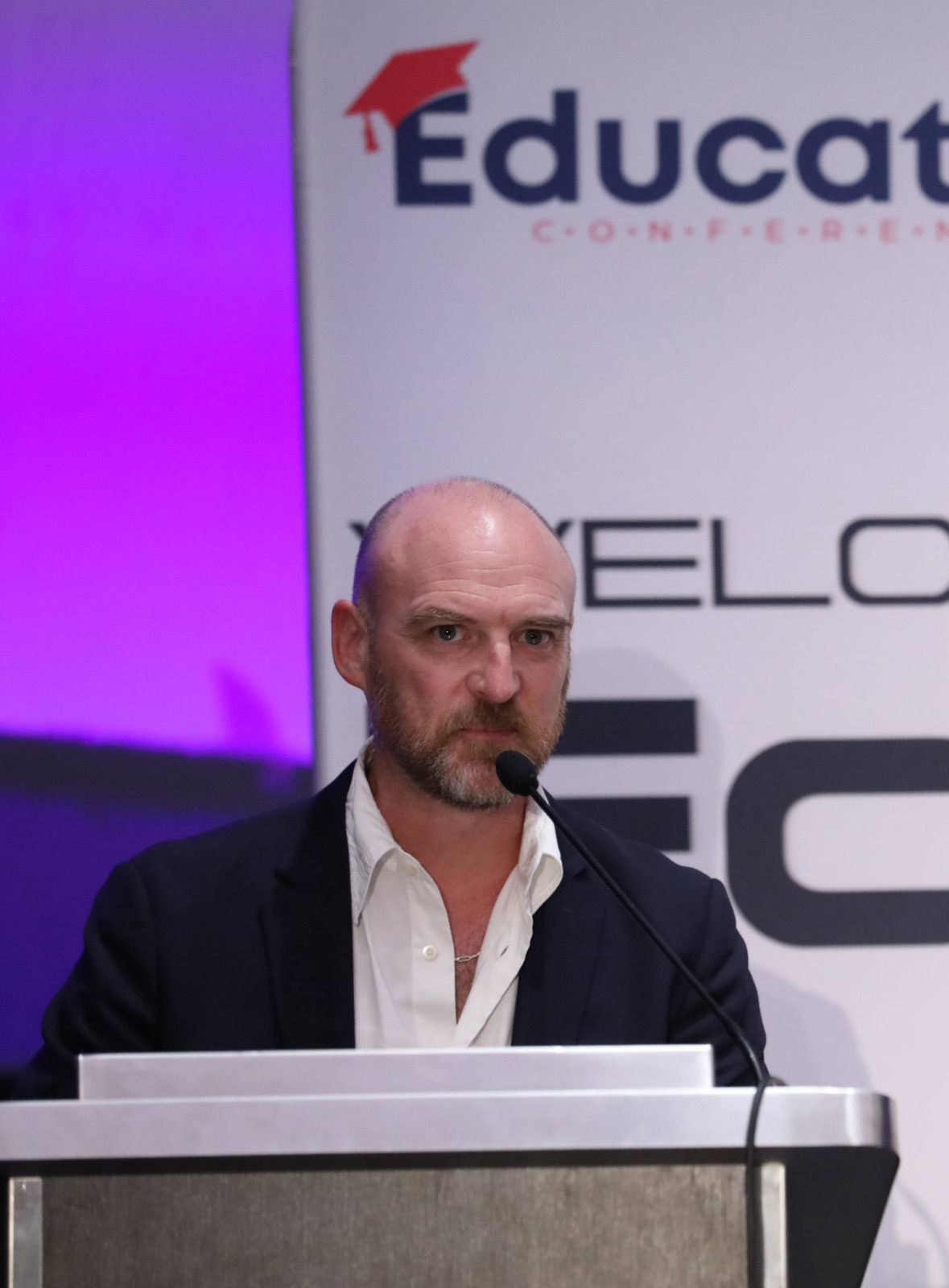 Colin Boguski speaking at a lectern